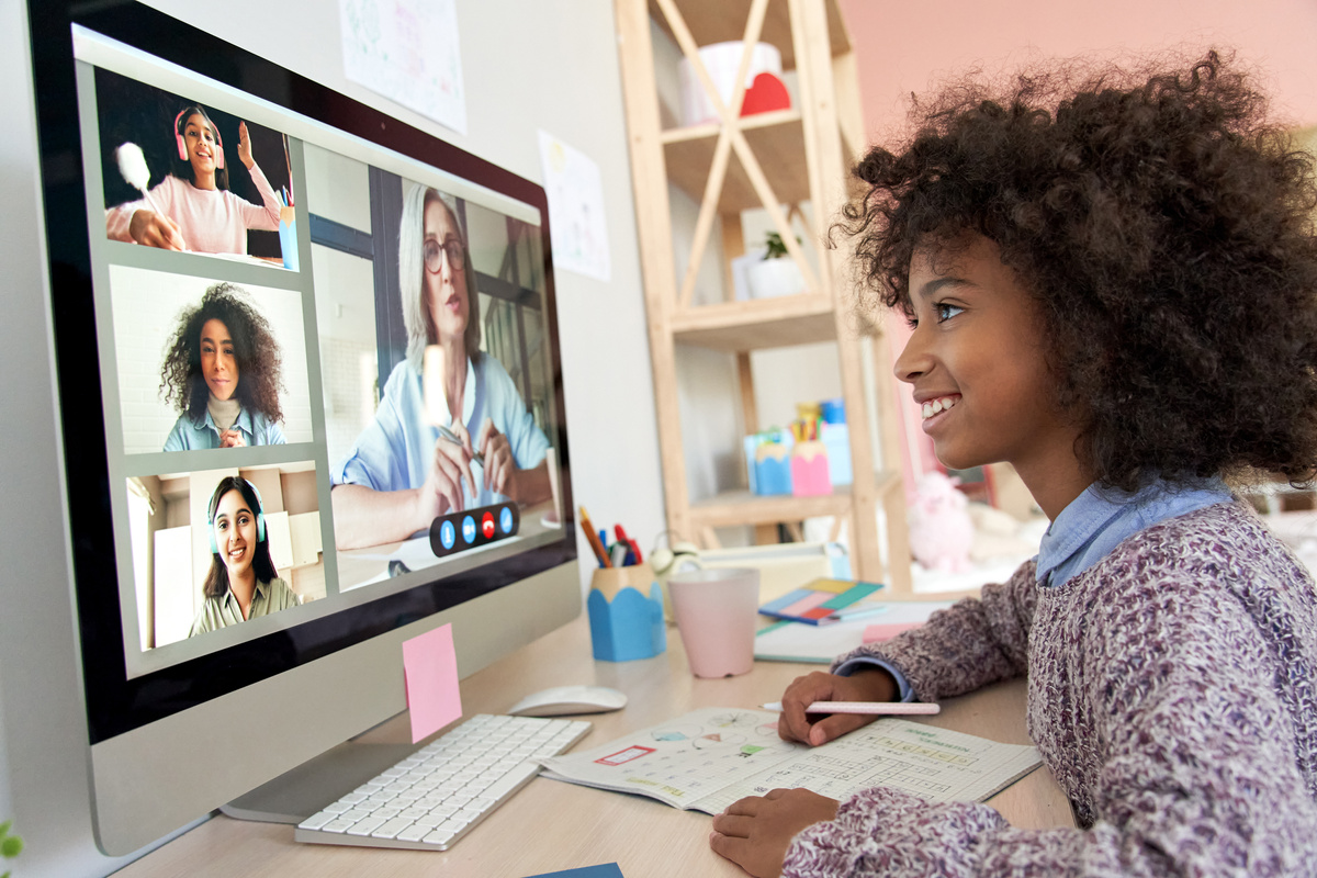 African Kid Girl Distance Learning during Online Group Class with Teacher.